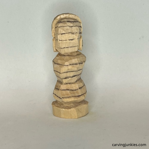 Lower lines on back of earworm caricature carving