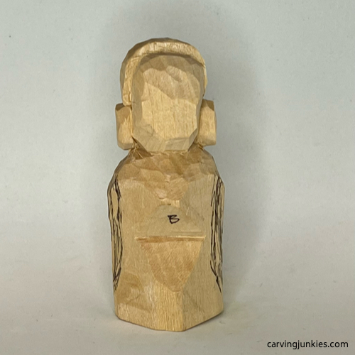 Back body of earworm caricature carving is marked for wood removal