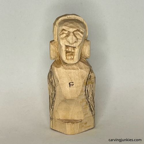 Front body of earworm caricature carving is marked for wood removal