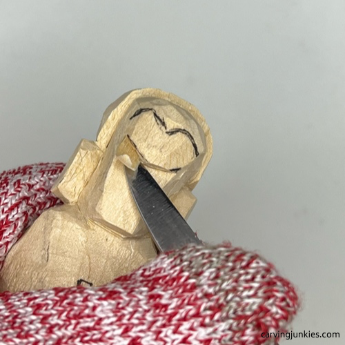 Starting the nose on earworm caricature carving