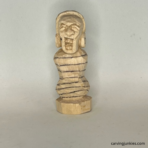 Lower lines on front of earworm caricature carving