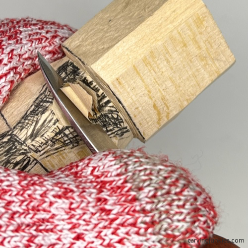 Removing wood from the front of the earworm caricature carving