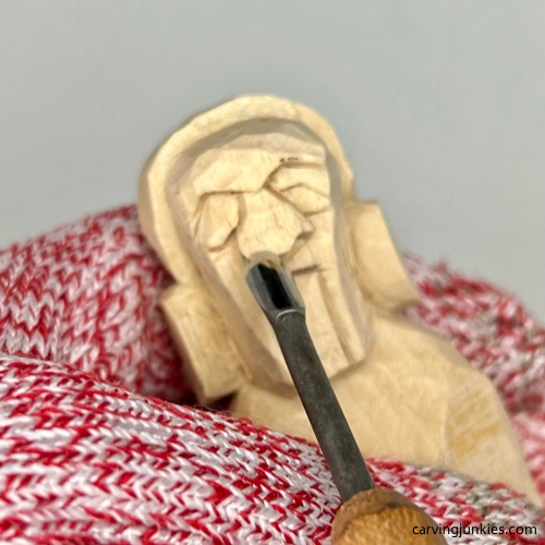 Using micro gouge to carve nostrils on earworm caricature carving