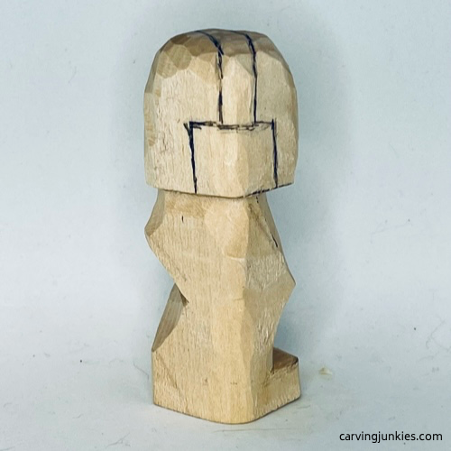 Sketched headphones on right side of earworm caricature carving