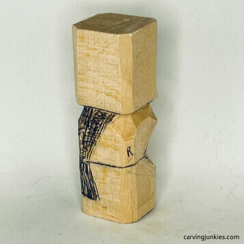 Right view of wood marked for removal on earworm caricature carving