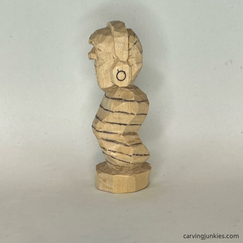 Lower lines on left of earworm caricature carving