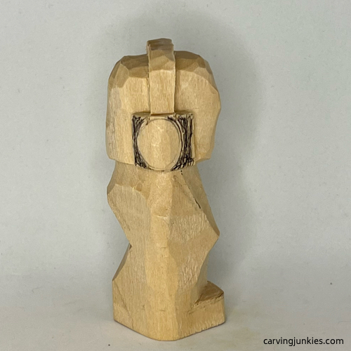 Right view of earworm caricature carving with oval