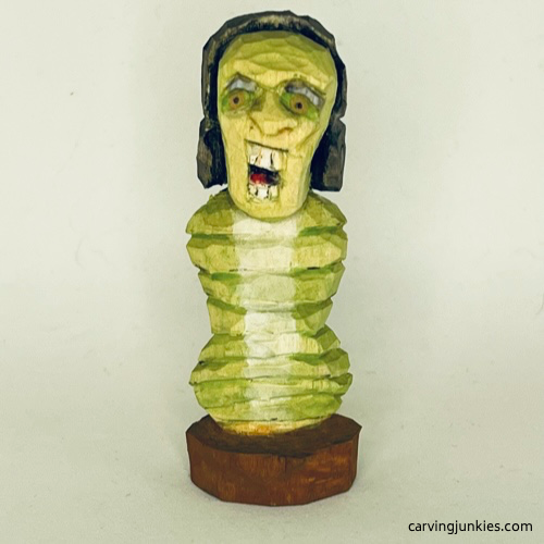 Front of painted earworm caricature carving