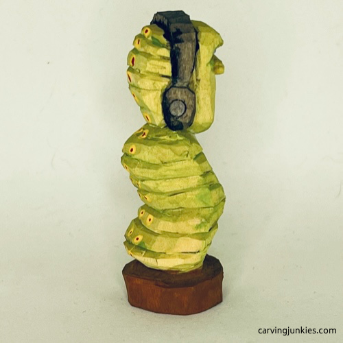 Right view of painted earworm caricature carving