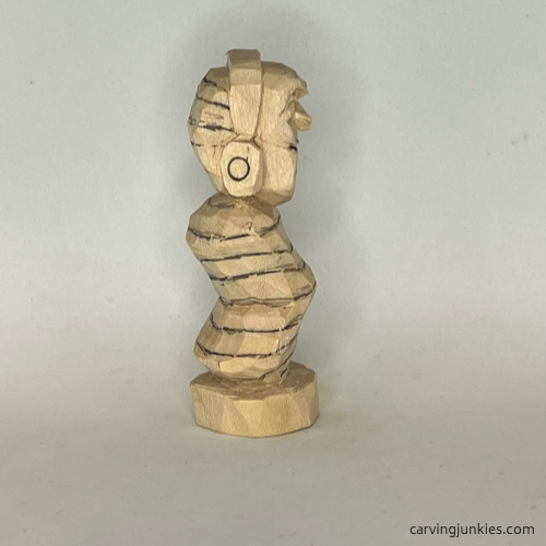 Lower lines on front of earworm caricature carving Lower lines on front of earworm caricature carving Lower lines on right of earworm caricature carving