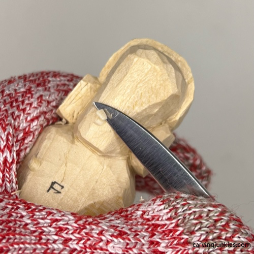 Narrowing face on earworm caricature carving