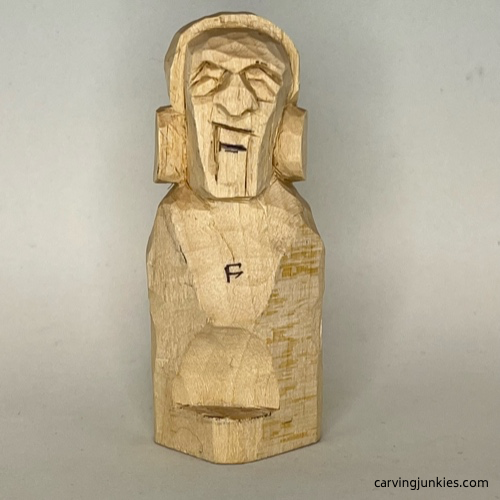 Sketching top teeth on earworm caricature carving