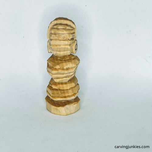 Unpainted back of earworm caricature carving