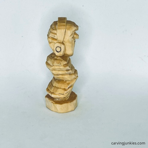 Unpainted right side of earworm caricature carving