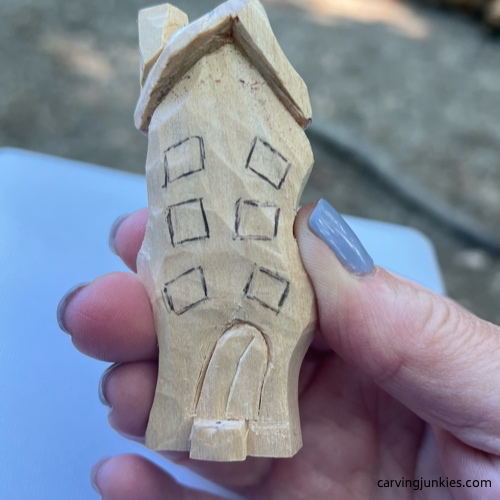 Windows are drawn on easy wood whittled house