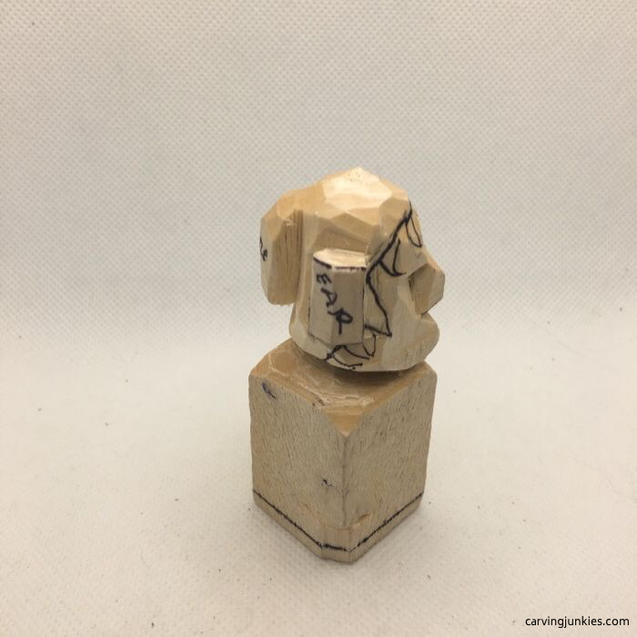 Side view of elf carving