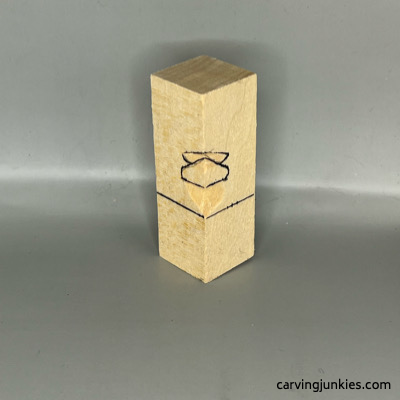 Eyes and nose are sketched for wood carved green man