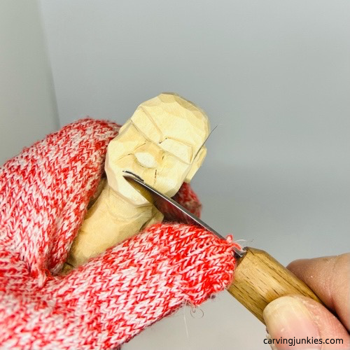 Cutting the chin on screw-up fairy wood caricature Shaping chin on screw-up fairy wood caricature