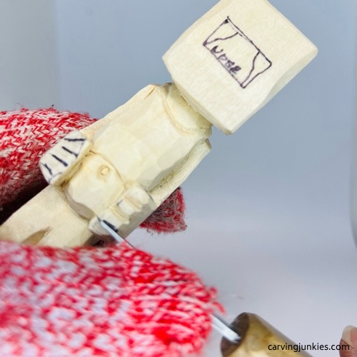 Shaping fingers on screw-up fairy wood caricature Carving fingers on screw-up fairy wood caricature