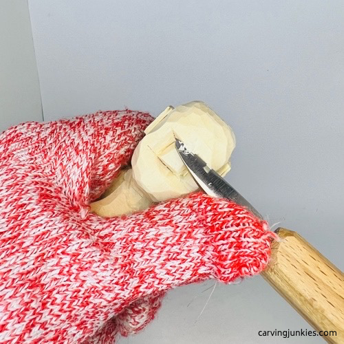 Cutting forehead back on screw-up fairy wood caricature Carving forehead on screw-up fairy wood caricature