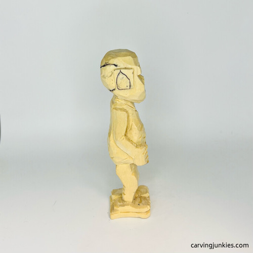 Right view of carved details on screw-up fairy wood caricature Right ear drawn on screw-up fairy wood caricature