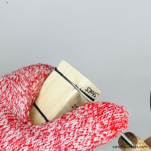 Stop cut with knife on screw-up fairy wood caricature Making stop cut on screw-up fairy wood caricature