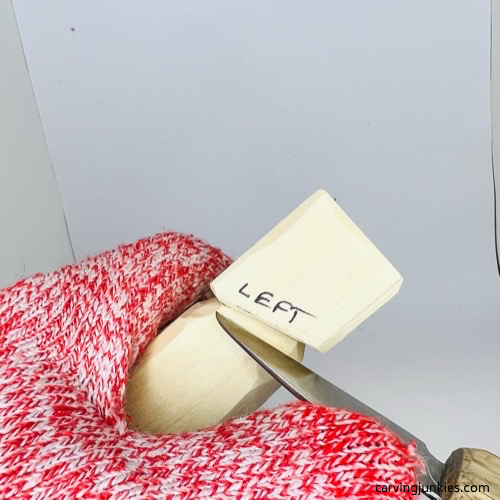 Carving the shoulders on a screw-up fairy wood caricature Cutting the shoulders on a screw-up fairy wood caricature