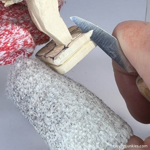 Carving slippers on screw-up fairy wood caricature Shaping slippers on screw-up fairy wood caricature