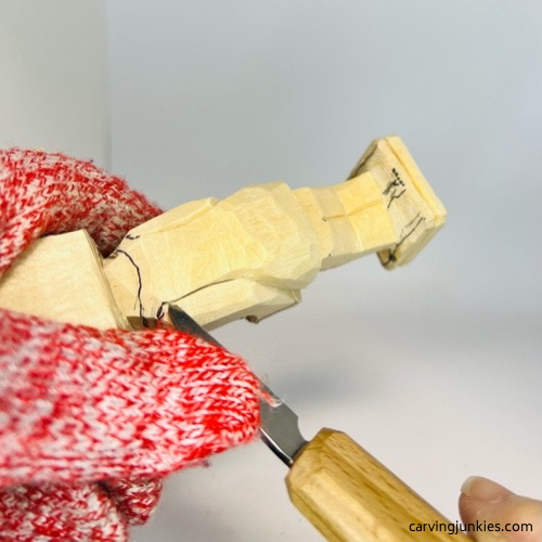 Cutting undershirt on screw-up fairy on wood caricature Carving undershirt on screw-up wood caricature