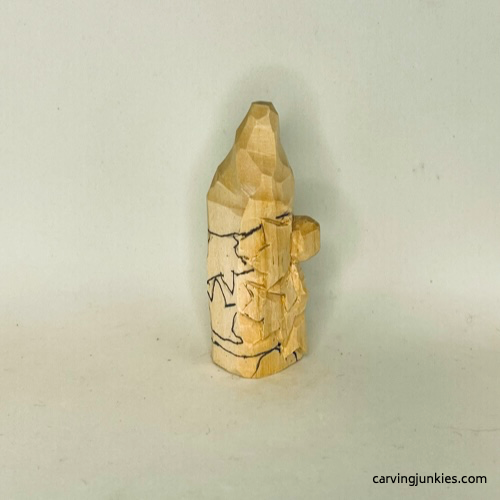 Right side of details on wood carved autumn gnome Right details sketched on fall gnome wood carving