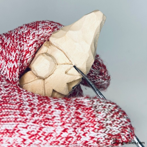 Carving acorn hat on wood carved autumn gnome Separating hat on wood carved fall gnome