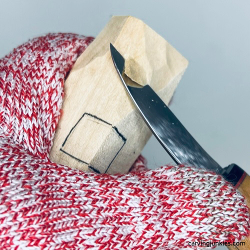 Shaping wood carved fall gnome with a knife Carving hat on wood carved fall gnome