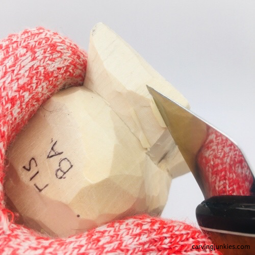 Shaving wood off fish carving