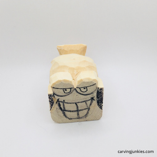 Caricature eyes on wooden fish carving