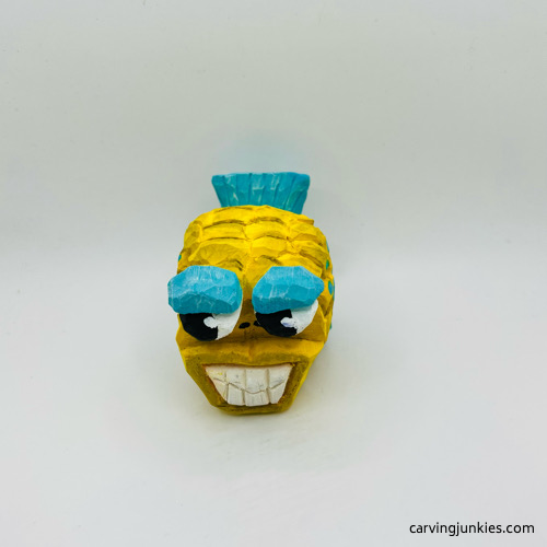 Front view of fish carving with paint Front side of painted fish carving