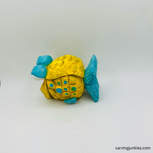 Left view of fish carving after painting Left side of painted fish carving