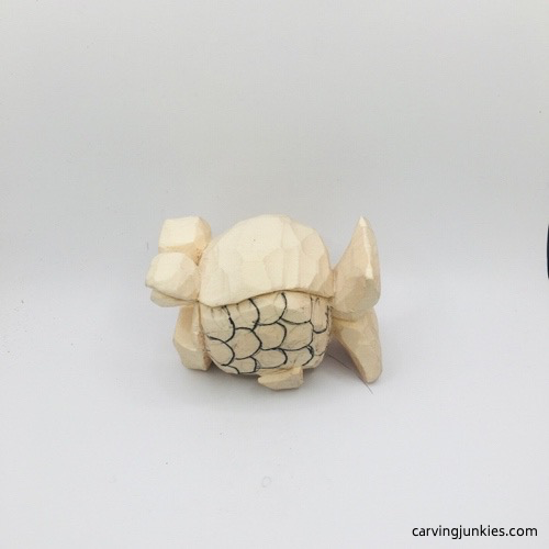 Scale pattern on wooden fish carving