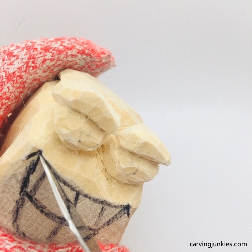 Carving mouth on wooden fish carving