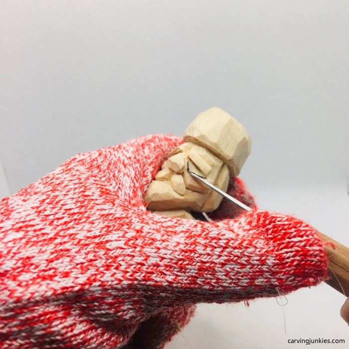 Carving eyes on little wooden man