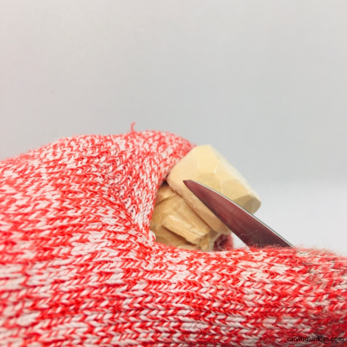 Shaping hat on carved little man