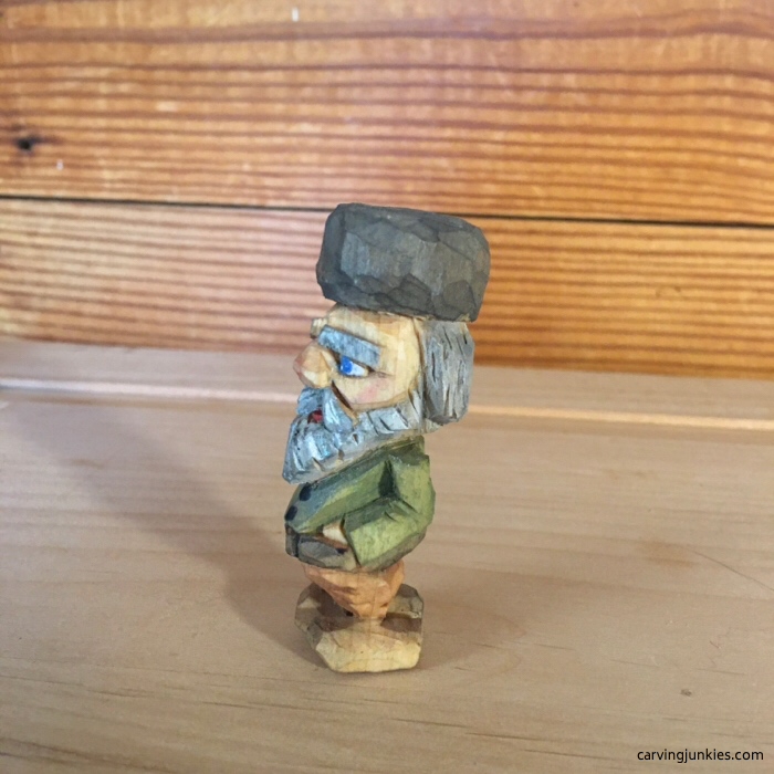 Left view of painted flat plane carving