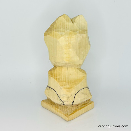 Drawn back legs on frog carving