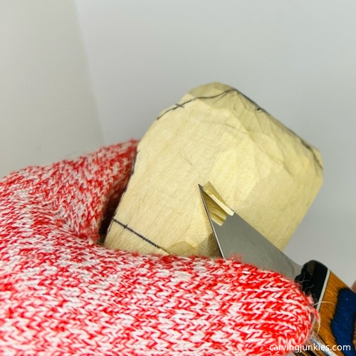 Shaping face of wooden frog carving