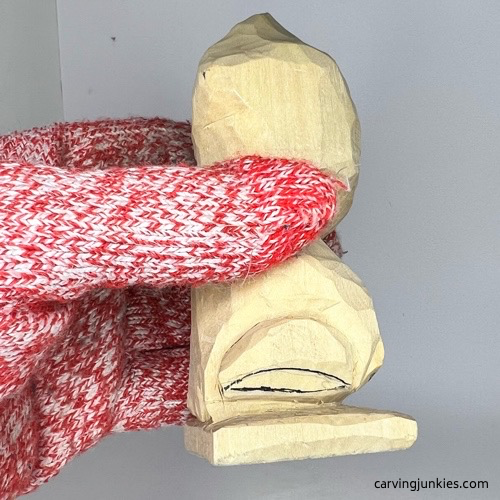 Left view of hind legs on frog carving