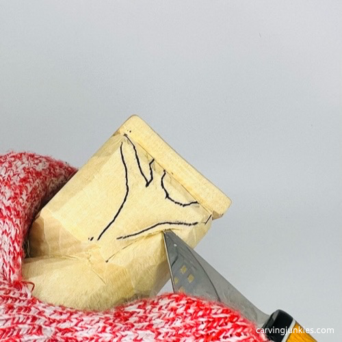 Slicing wood on frog carving