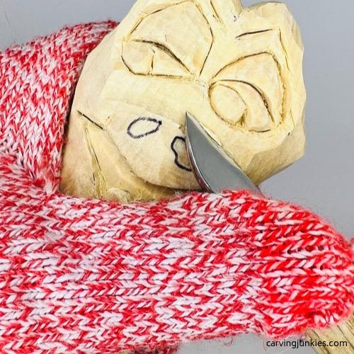 Shaping nose mound on frog carving