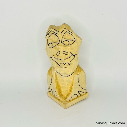 Drawn neck on frog carving