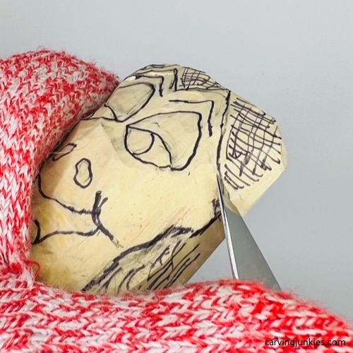 Refining face on frog caricature carving