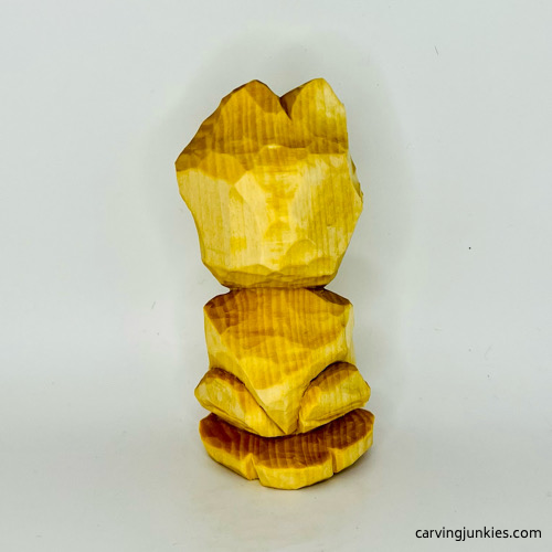 Back view of unpainted wooden frog carving