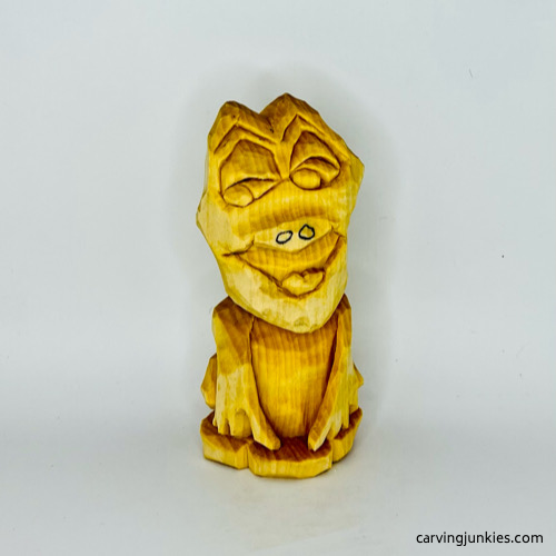 Front of unpainted frog wood carving